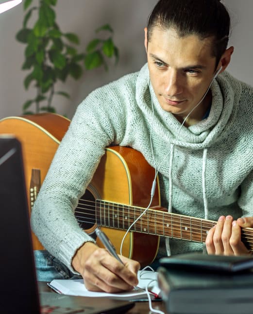 Adult student taking online guitar class